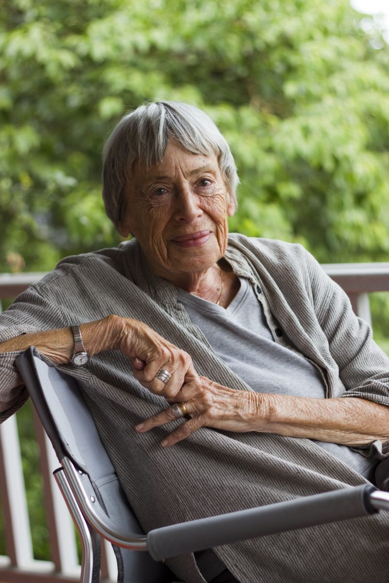 Ursula K. Le Guin seated and turned toward the camera with a peaceful smile