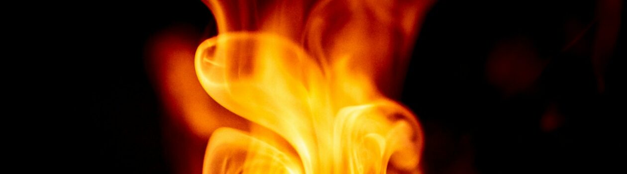 flame in the shape of a heart against a dark background