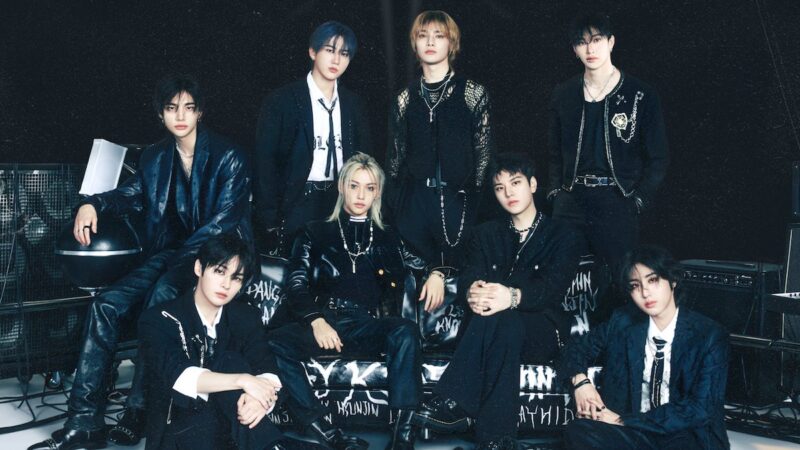photoshoot of eight members of Stray Kids, all wearing black